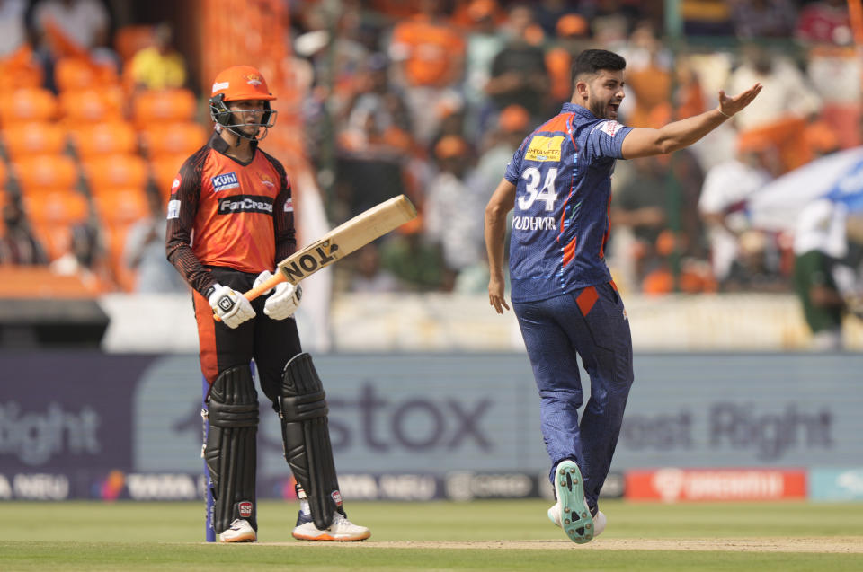 Lucknow Super Giants bowler Yudhvir Singh, right, appeals successfully for the wicket of Sunrisers Hyderabad's Abhishek Sharma, left, during the Indian Premier League cricket match between Sunrisers Hyderabad and Lucknow Super Giants in Hyderabad, Saturday, May 13, 2023. (AP Photo/Mahesh Kumar A.)