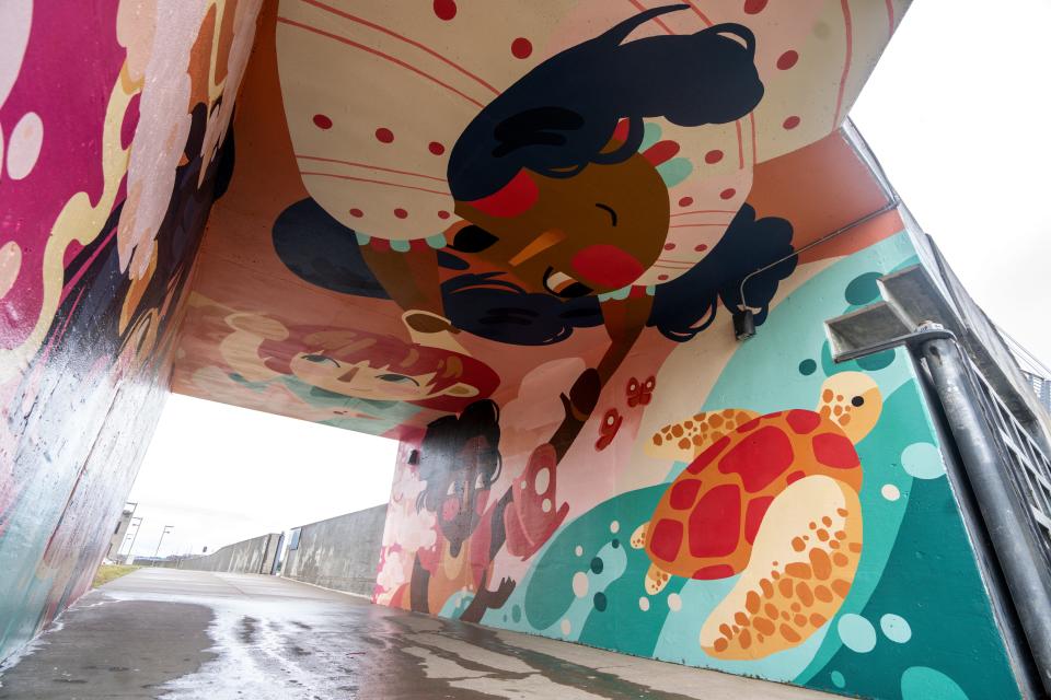 A mural called "We Are One" by Ally Frame is seen under the eastern side of the Iowa Women of Achievement Bridge in Des Moines.
