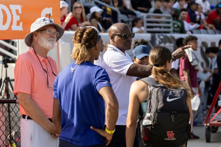 US Olympics great Carl Lewis (2nd R) interacts with members of the audience and athletes at the Mt. SAC Relays in Walnut, California (ETIENNE LAURENT)