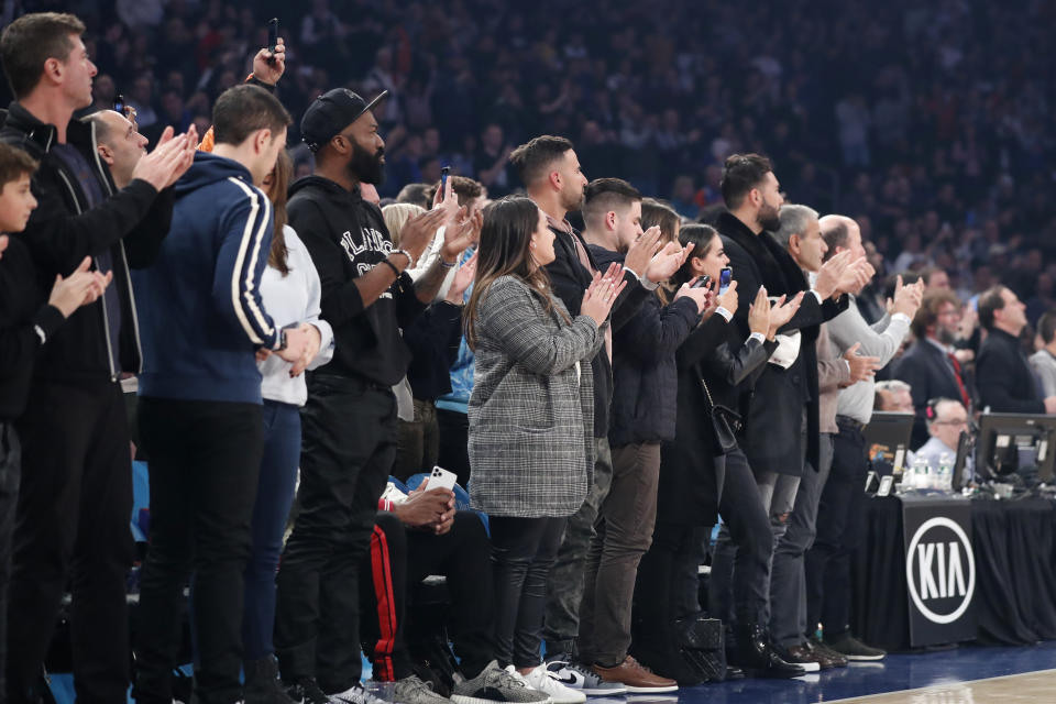 Fans applaud as players hold onto the ball as the 24 second clock runs out in a tribute to retired Los Angeles Lakers star Kobe Bryant who died in a helicopter crash in California before the start of an NBA basketball game between the Brooklyn Nets and the New York Knicks at Madison Square Garden in New York, Sunday, Jan. 26, 2020. Fans also repeatedly shouted out Kobe's name. (AP Photo/Kathy Willens)