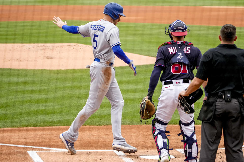 Los Angeles Dodgers' Freddie Freeman (5) scores on a single by Jason Heyward during the first inning of a baseball game against the Washington Nationals at Nationals Park, Sunday, Sept. 10, 2023, in Washington. (AP Photo/Andrew Harnik)