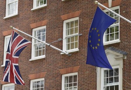 The British Union flag and European Union flag are seen hanging outside Europe House in central London June 9, 2015. REUTERS/Toby Melville