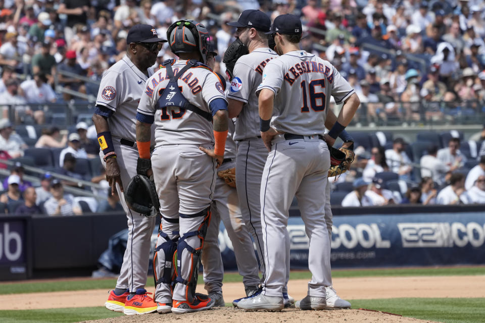 Houston Astros starting pitcher Justin Verlander, center, has a mound conference with pitching coach Joshua Miller, left, in the seventh inning of a baseball game against the New York Yankees, Saturday, Aug. 5, 2023, in New York. (AP Photo/Mary Altaffer)