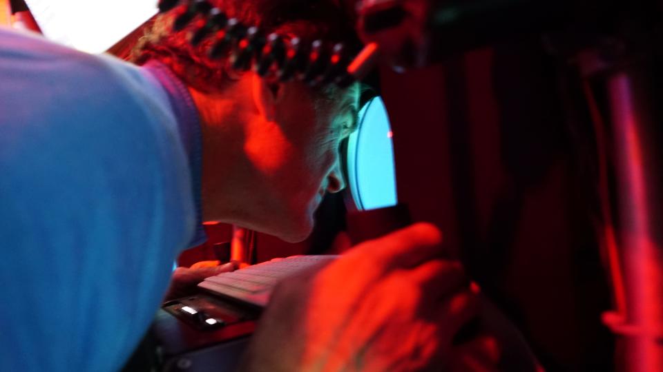 Falmouth resident Bruce Strickrott, lead pilot for the Woods Hole Oceanographic Institution's submersible Alvin, peers out a porthole during a deep-sea research cruise.