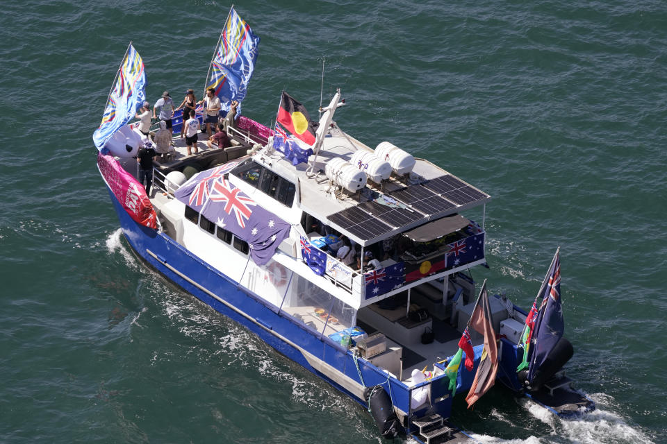 People are entertained on a boat on Sydney Harbour during Australia Day celebration in Sydney, Thursday, Jan. 26, 2023. Australia marks the anniversary of British colonists settling modern day Sydney in 1788 while Indigenous protesters deride Australia Day as Invasion Day. (AP Photo/Rick Rycroft)