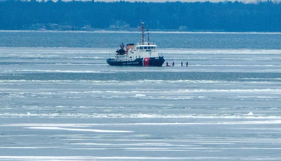 Personnel from the U.S. Coast Guard cutter Mobile Bay walk in the ice Wednesday, January 18, 2023 on Green Bay about 10 miles north of Green Bay, Wis. Ice has been slow to form this year with only 3 percent of the lakes covered as of Jan. 13. The near-record low is roughly 18 percent below average for this time of year.