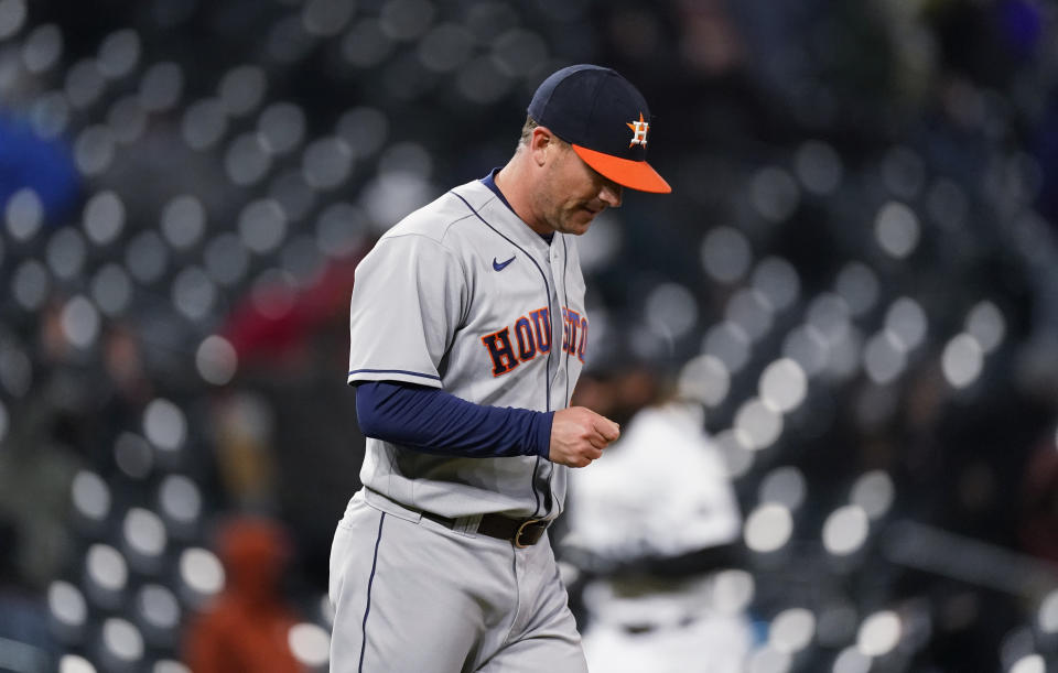 Houston Astros relief pitcher Joe Smith looks down after giving up a three-run home run to Colorado Rockies' C.J. Cron during the eighth inning of a baseball game Tuesday, April 20, 2021, in Denver. (AP Photo/David Zalubowski)
