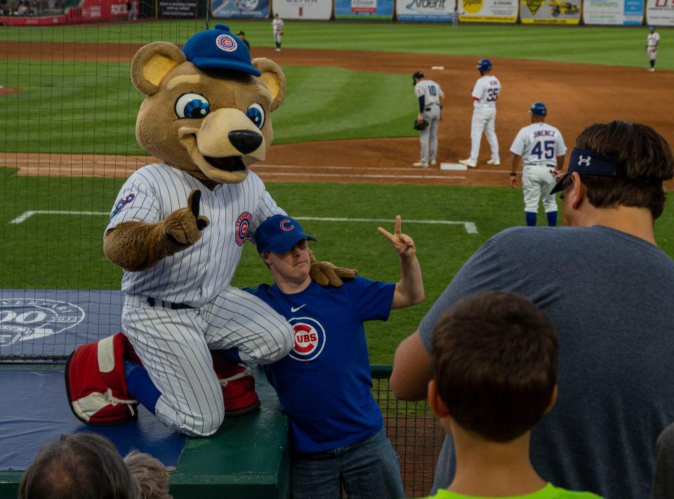 Stu the Bear takes pictures with a fan during the South Bend Cubs v. Lake County Captains game on Thursday, July 28, 2022.