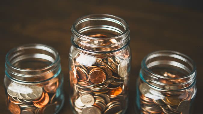 Money jars filled with American currency.