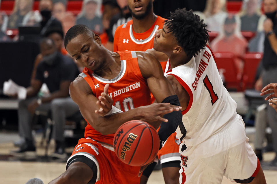 Sam Houston State's Zach Nutall (10) and Texas Tech's Terrence Shannon Jr. (1) try to rebound the ball during the first half of an NCAA college basketball game Friday, Nov. 27, 2020, in Lubbock, Texas. (AP Photo/Brad Tollefson)