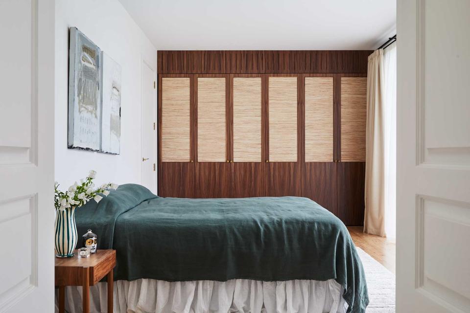 a bedroom with a coverlet styled bed