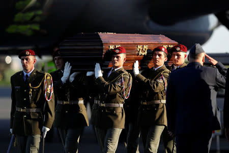 Soldiers carry a coffin with the remains of Czech cardinal Josef Beran after its arrival to Kbely airport in Prague, Czech Republic, April 20, 2018. REUTERS/David W Cerny