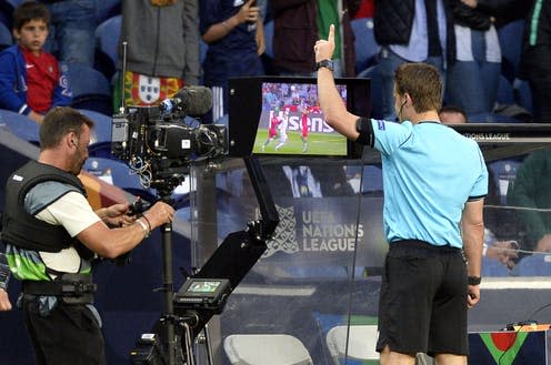 <span class="caption">German referee Felix Brych looks at a replay of the video assistant referee (VAR) during the UEFA Nations League semi final soccer match between Portugal and Switzerland, June 2019</span> <span class="attribution"><span class="source">EPA-EFE/Fernando Veludo</span></span>