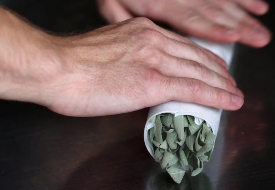 Chef Juan Camilo Liscano bundles sage which is part of Palma’s granita dessert.