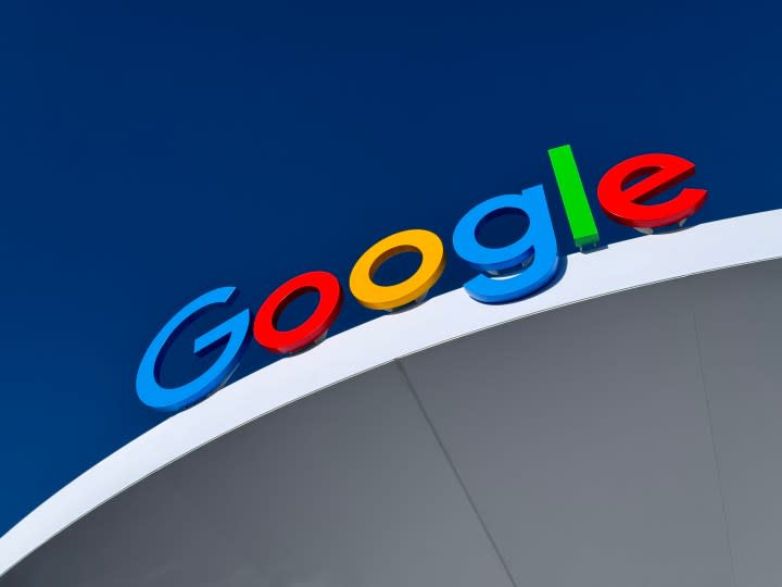 A Google logo sign at the top of a building.