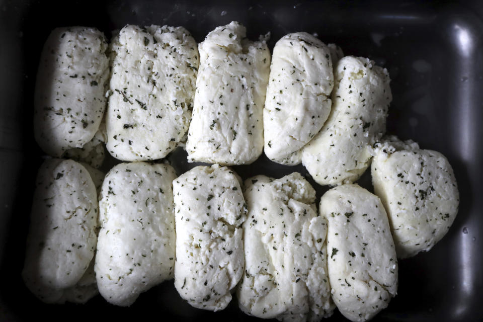 In this photo taken Wednesday Dec. 11, 2019, Cyprus' halloumi cheeses are seen after salting at a farm in Kampia village near Nicosia, Cyprus. Cyprus' halloumi cheese, with a tradition dating back some five centuries, is the island nation's leading export. It's goat and sheep milk content makes it a hit with health-conscious cheese lovers in Europe and beyond. It's added appeal is that unlike other cheeses, it doesn't melt when heated up. (AP Photo/Petros Karadjias)