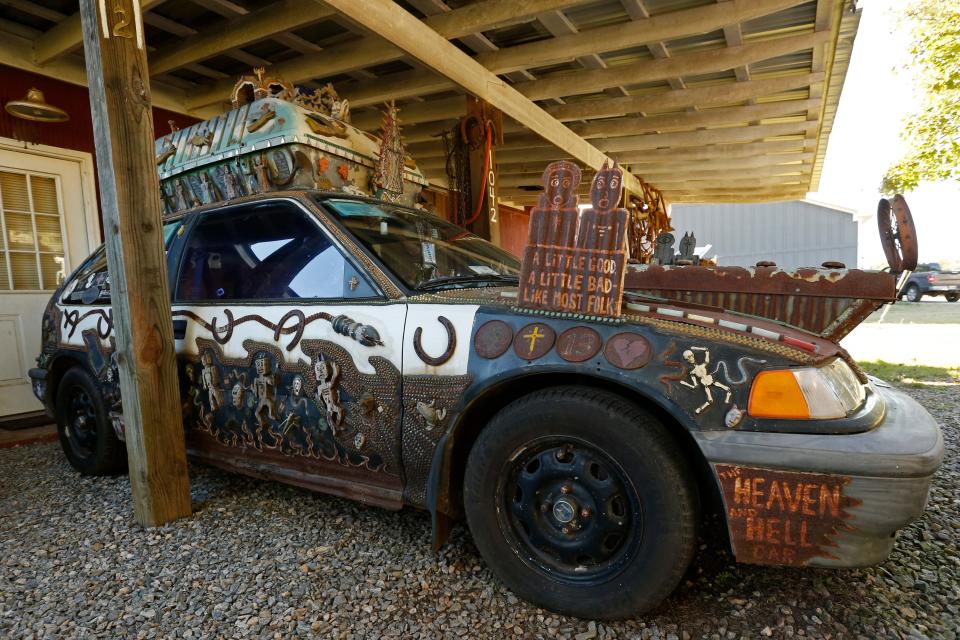Folk artist Chris Hubbard's Heaven and Hell art car parked at his home in Farmington, Ga., on Wednesday, Oct. 5, 2022. The car is a 1990 Honda and Hubbard turned it into an art car in 1998 and traveled around the country to folk festivals.