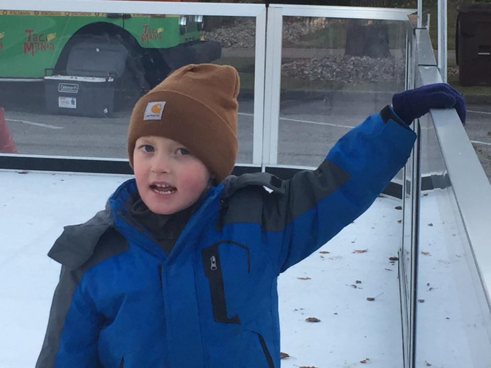 Cash Music, 4, of Plymouth, holds onto the side of the iceless skating rink.