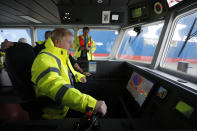 Britain's Prime Minister Boris Johnson steers a tug boat during a General Election campaign stop in the port of Bristol, England, Thursday, Nov. 14, 2019. Britain goes to the polls on Dec. 12. (AP Photo/Frank Augstein, Pool)