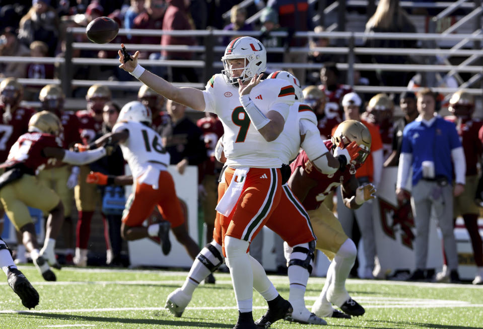 Miami quarterback Tyler Van Dyke (9) gets off a pass during the first half of an NCAA college football game against Boston College Friday, Nov. 24, 2023 in Boston. (AP Photo/Mark Stockwell)