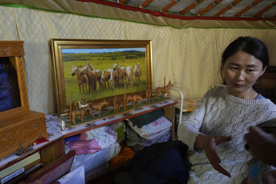 Nurmaa, the wife of herder Agvaantogtokh, packs her belongings to move to a new location in the Munkh-Khaan region of the Sukhbaatar district, in southeast Mongolia, Monday, May 15, 2023. Every time the family moves its ger, each belonging is systematically placed in the same spot — something stable and predictable in a world of constant change. (AP Photo/Manish Swarup)