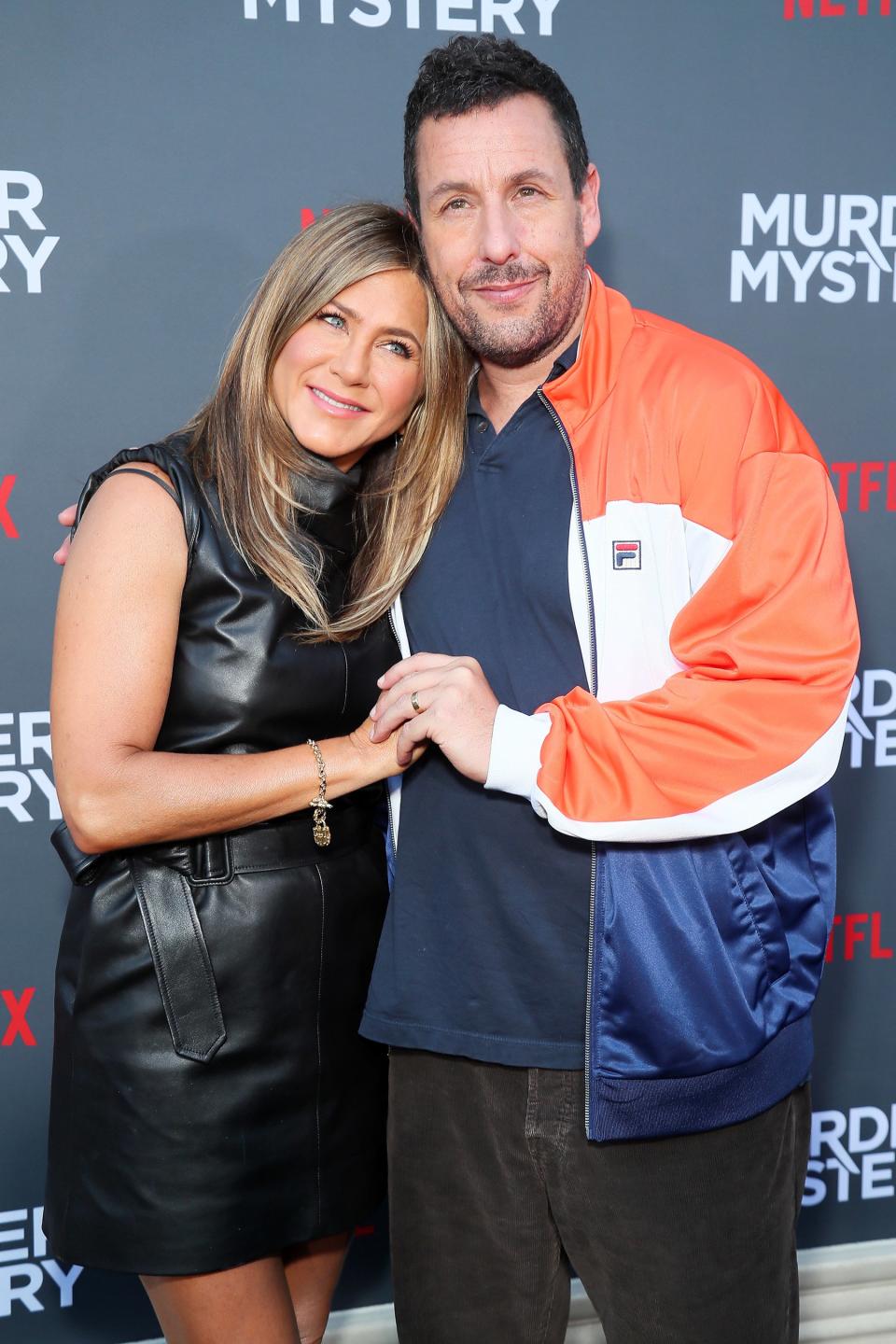 Costars Jennifer Aniston and Adam Sandler embrace at the premiere of Netflix’s <em>Murder Mystery</em> at the Regency Village Theatre on Monday in Westwood, California.