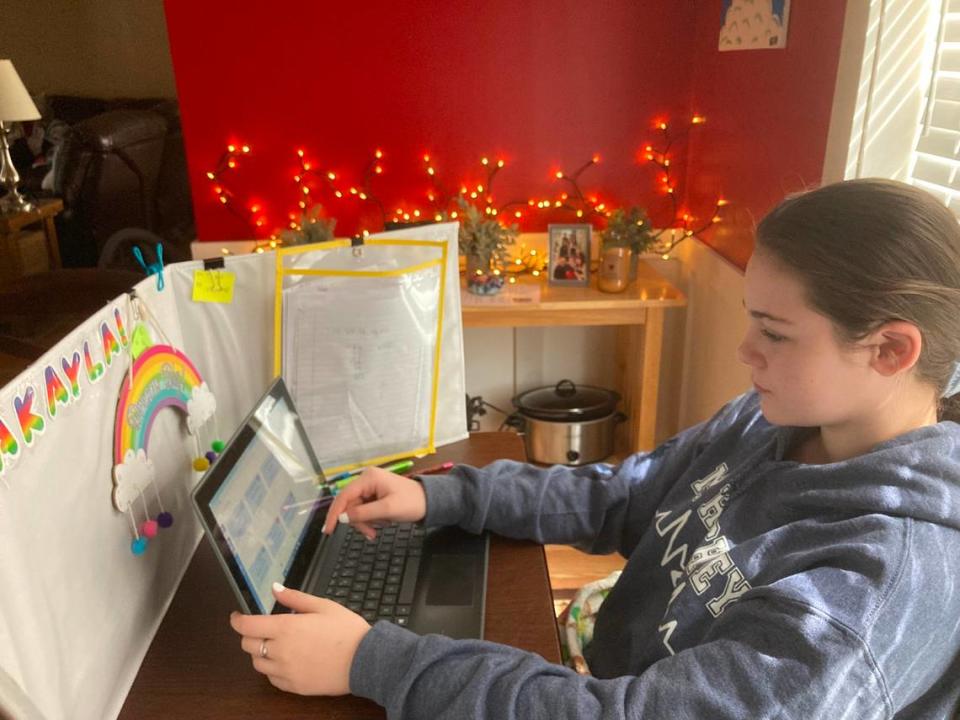 MaKayla Hinchey doing virtual assignments at her desk at home.