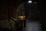 A woman prays at the St. Michael's Golden-Domed Monastery in Kyiv, Ukraine, Tuesday Jan. 31, 2023. (AP Photo/Daniel Cole)