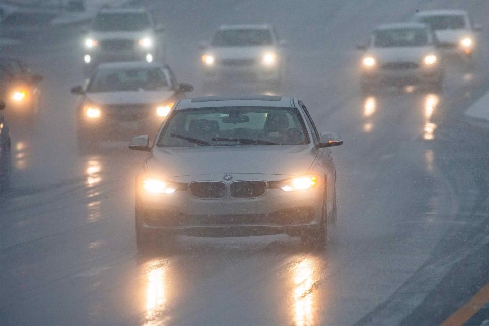 Drivers face a messy commute along Concord Pike as a combination of rain and snow falls during the early morning hours in Wilmington, Tuesday, Feb.13, 2024.