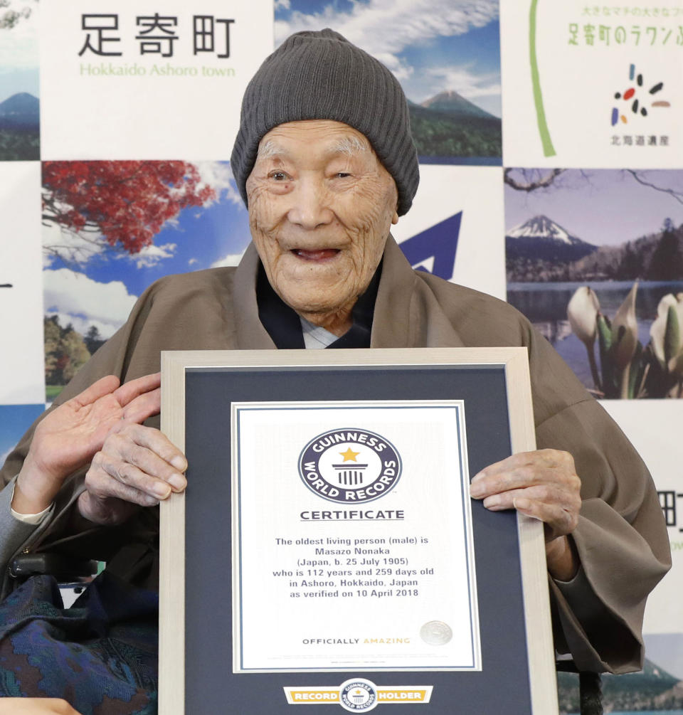 In this April 10, 2018, file photo, Masazo Nonaka eats a cake after receiving the certificate from Guinness World Records as the world's oldest living man at then age 112 years and 259 days during a ceremony in Ashoro on Japan's northern main island of Hokkaido. In the early hours of Sunday, Jan. 20, 2019, Nonaka died at his home _ a hot springs inn _ in northern Japan at the age of 113. (Masanori Takei/Kyodo News via AP)