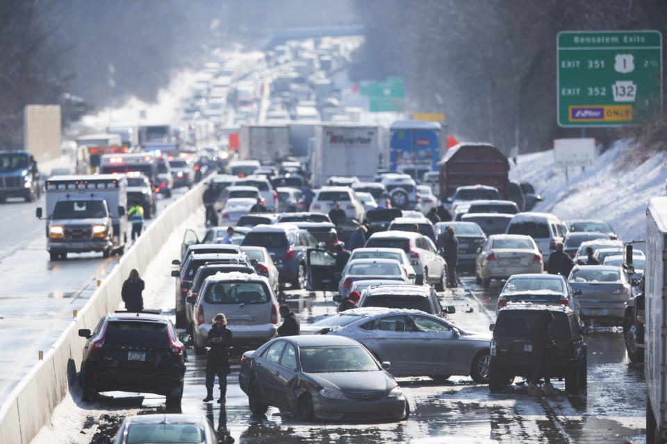 Vehicles are piled up in an accident Friday, Feb. 14, 2014, in Bensalem, Pa. Traffic accidents involving multiple tractor trailers and dozens of cars have completely blocked one side of the Pennsylvania Turnpike outside Philadelphia and caused some injuries. (AP Photo/Matt Rourke)