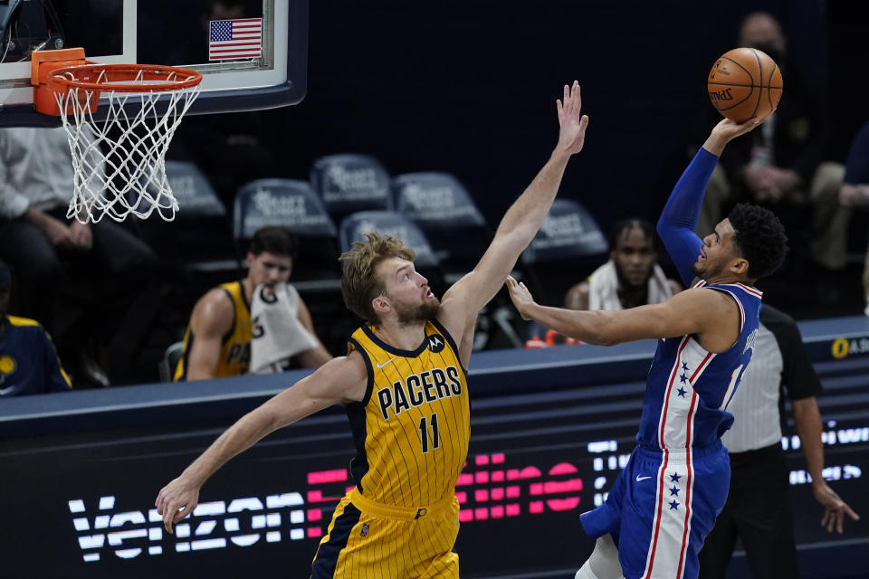 Philadelphia 76ers' Tobias Harris (12) shoots over Indiana Pacers' Domantas Sabonis (11) during the second half of an NBA basketball game, Tuesday, May 11, 2021, in Indianapolis. (AP Photo/Darron Cummings)