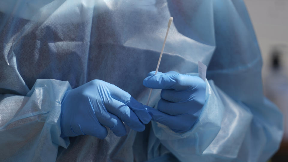 FILE - A nurse gives a COVID-19 test outside the Salt Lake County Health Department Friday, July 22, 2022, in Salt Lake City. On Friday, Dec. 9, 2022, The Associated Press reported on stories circulating online incorrectly claiming a COVID-19 test patent application is dated 2020 but was actually filed in 2015. (AP Photo/Rick Bowmer, File)