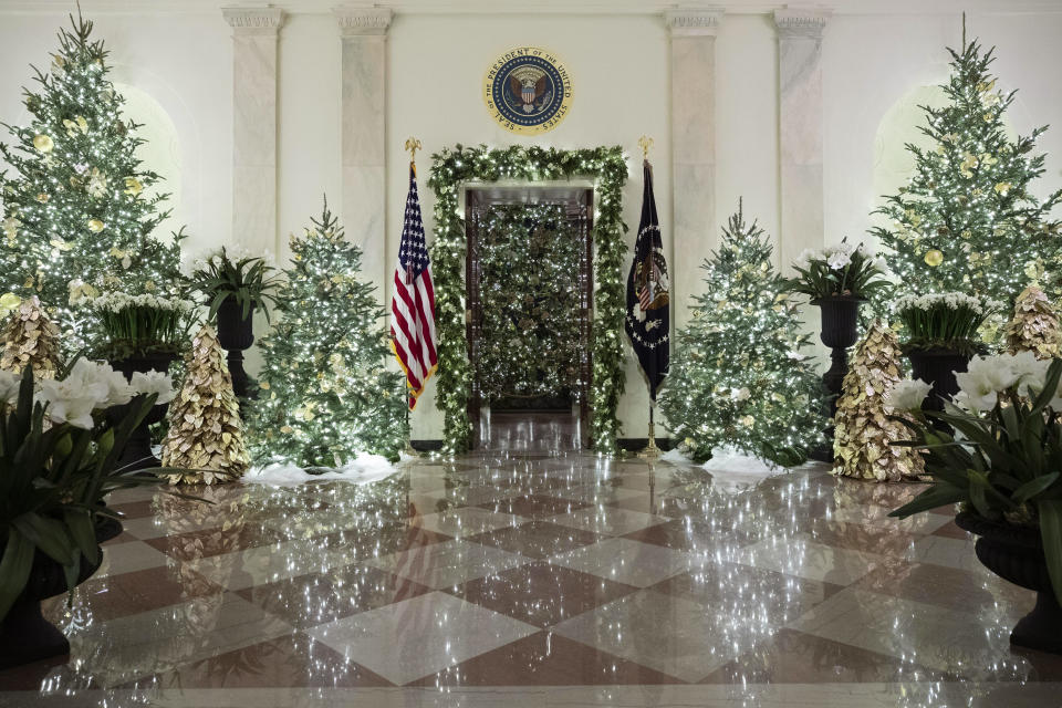 The official White House Christmas tree is decorated in the Blue Room seen through the Cross Hall, during the 2019 Christmas preview at the White House, Monday, Dec. 2, 2019, in Washington. (AP Photo/Alex Brandon)