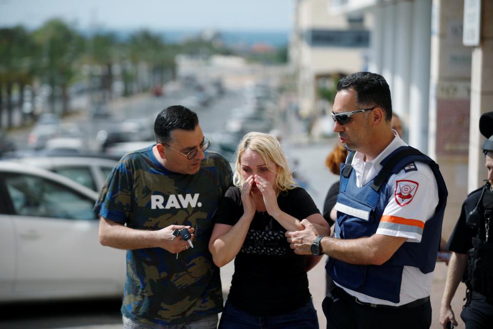 A woman in Ashkelon at the scene of a rocket attackReuters