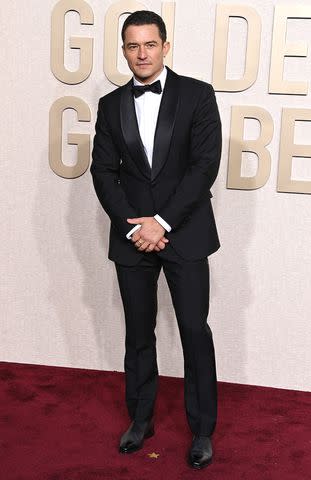 <p>Jon Kopaloff/WireImage</p> Orlando Bloom attends the 81st Annual Golden Globes Awards on Jan. 7, 2024.
