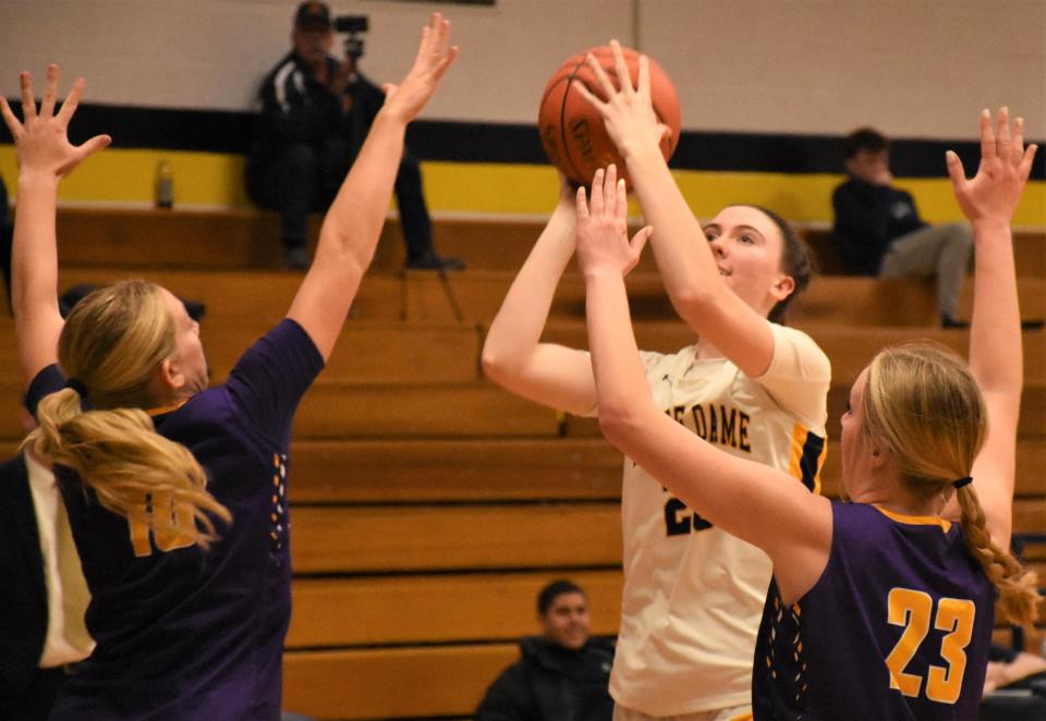 Notre Dame's Ella Trinkaus attempts a shot Thursday with Kirsten Lighthall and Riley Mierek (23) defending for Holland Patent. Trinkaus scored 22 points as the Jugglers won their home opener in Utica 66-34.