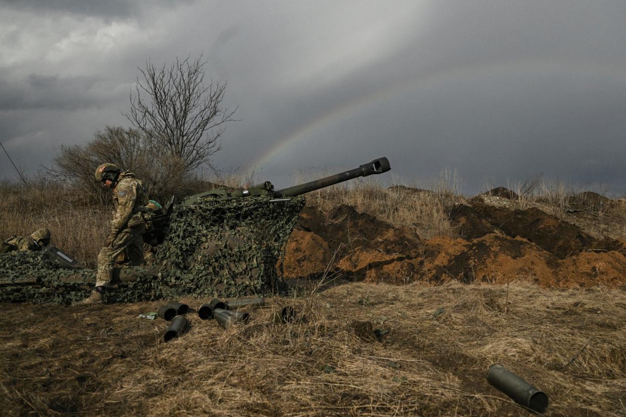 Ukrainian servicemen fire with a 105mm howitzer towards Russian positions near the city of Bakhmut, yesterday (AFP via Getty Images)