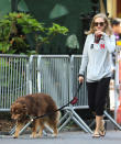 <p>The actress may have been in a sweatshirt, but walking her dog, Finn, clearly called for a cool beverage. (Photo: AKM-GSI) </p>