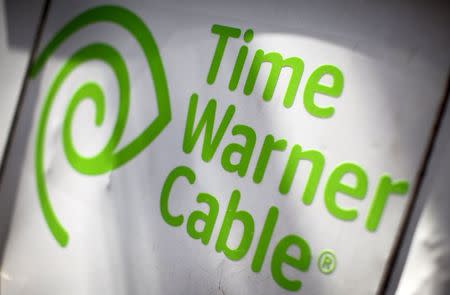 A Time Warner Cable sign and logo are seen on the back of a Time Warner Cable service truck in the Manhattan borough of New York City, May 26, 2015. REUTERS/Mike Segar