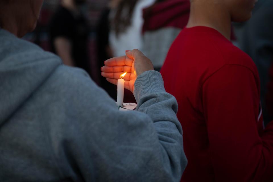 Hundreds gather at the Twin Lakes High School football field Wednesday night for a vigil honoring Kayvion Jackson, on June 8, 2022, in Monticello.