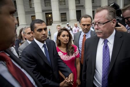 Former SAC Capital Advisors portfolio manager Mathew Martoma (C) exits the U.S. District Court for the Southern District of New York with his wife Rosemary (center R), following sentencing for insider trading, in Lower Manhattan, September 8, 2014. REUTERS/Brendan McDermid