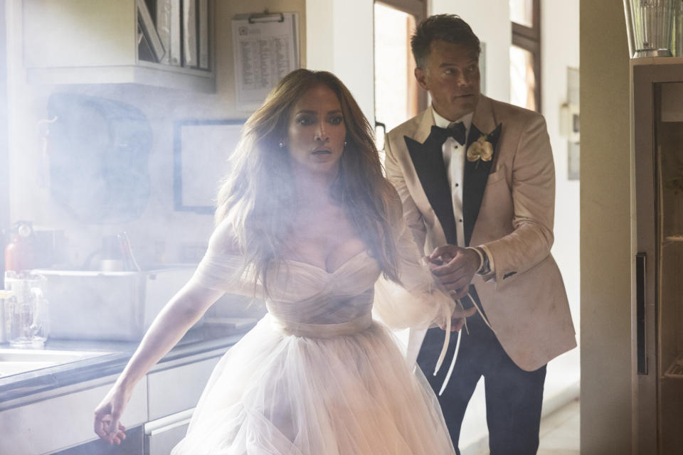 This image released by Lionsgate shows Jennifer Lopez, left, and Josh Duhamel in a scene from "Shotgun Wedding." (Ana Carballosa/Lionsgate via AP)