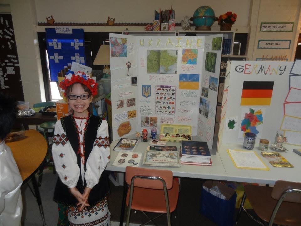 Amelie Nagle presenting her third-grade research project on Ukraine.