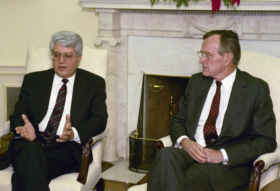 FILE - Israeli Foreign Minister David Levy, left, gestures while meeting with President George H. W. Bush in the Oval Office to discuss the progress of Middle East peace talks, Dec. 17, 1991, in Washington. Levy, an Israeli politician born in Morocco who fought tirelessly against deep-seated racism against Jews from North Africa and went on to serve as foreign minister and hold other senior governmental posts, died Sunday, June 2, 2024. He was 86. (AP Photo/Ron Edmonds, File)