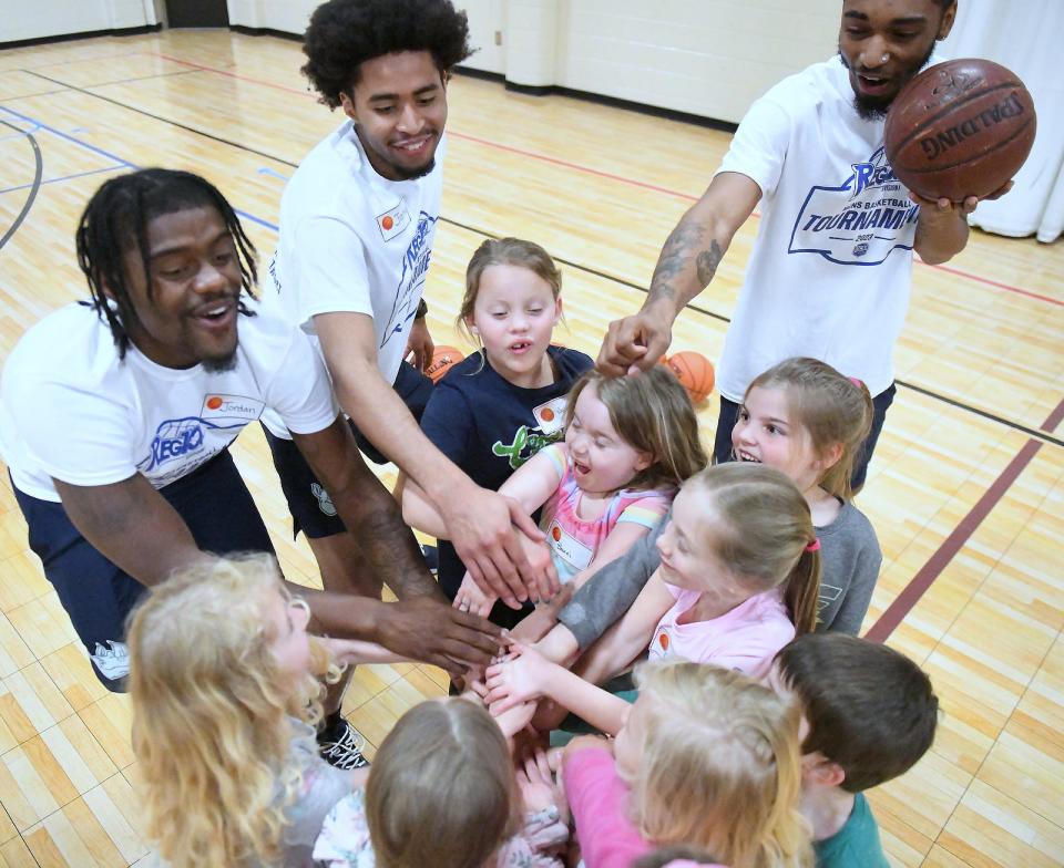 Gaston College Rhinos basketball players have fun with kids during their basketball clinic held Wednesday, March 22, 2023, at First United Methodist Church on East Franklin Boulevard.