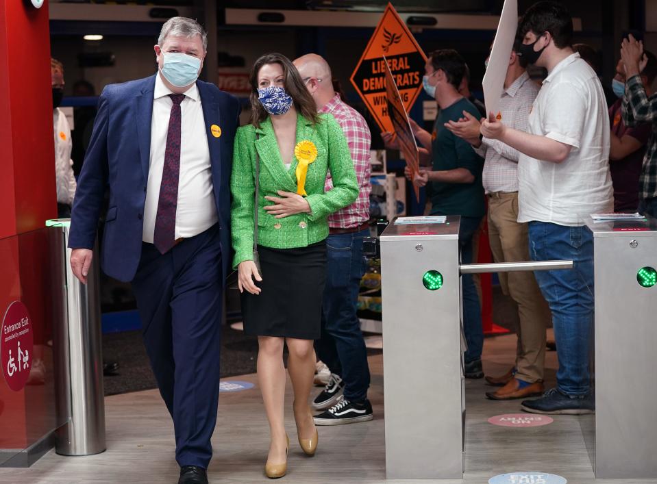 Liberal Democrat candidate Sarah Green and Alistair Carmichael, Liberal Democrat MP for Orkney and Shetland, are greeted by party supporters upon arriving for the declaration (PA)