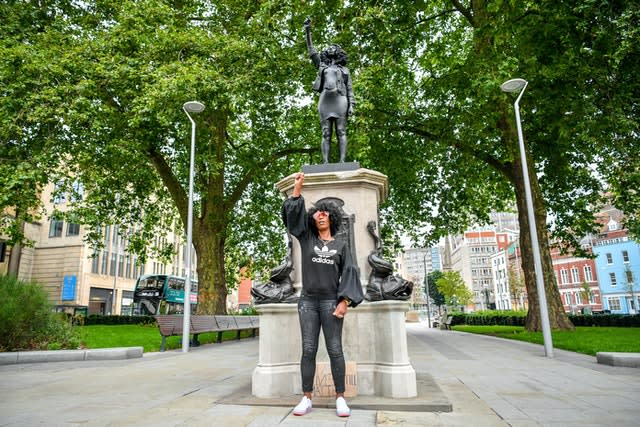 Jen Reid poses in front of the statue on Wednesday morning (Ben Birchall/PA)