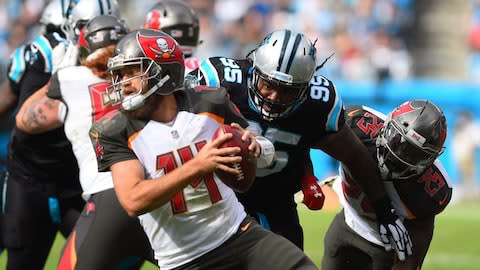 Tampa Bay Buccaneers quarterback Ryan Fitzpatrick (14) with the ball as Carolina Panthers defensive tackle Dontari Poe (95) pressures in the second quarter at Bank of America Stadium - Credit: Bob Donnan/USA Today