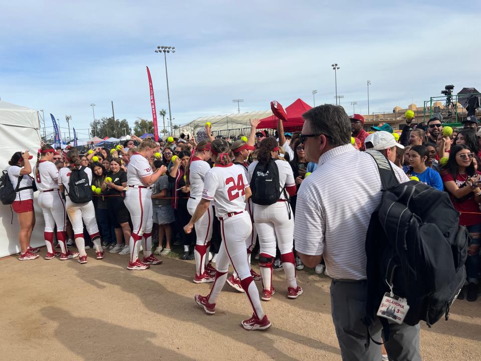 Oklahoma softball players sign autographs for fans after their win over San Diego State on Saturday at the Mary Nutter Collegiate Classic in Cathedral City, Calif.